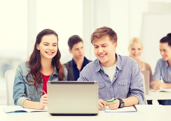 Students with laptop and notebooks at school — Stock Photo, Image