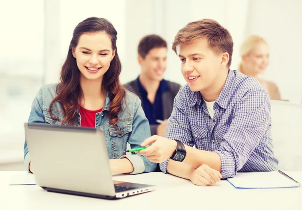 Students with laptop and notebooks at school — Stock Photo, Image