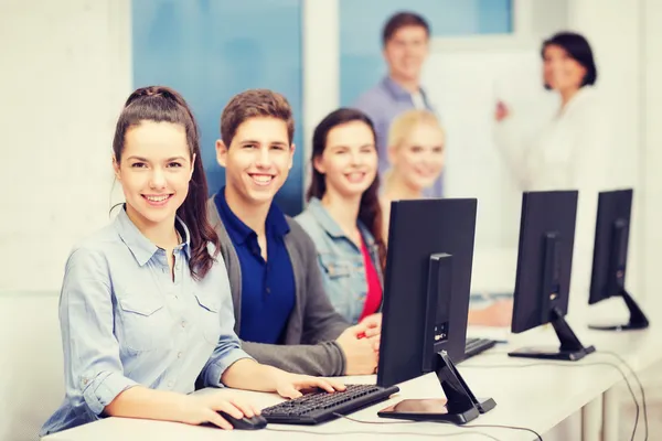 Students with computer monitor at school — Stock Photo, Image