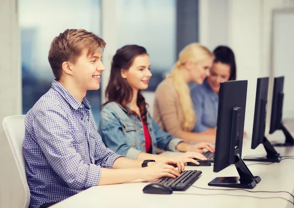 Students looking at computer monitor at school — Stock Photo, Image