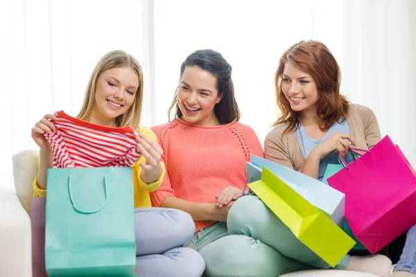 Smiling teenage girls with many shopping bags — Stock Photo, Image
