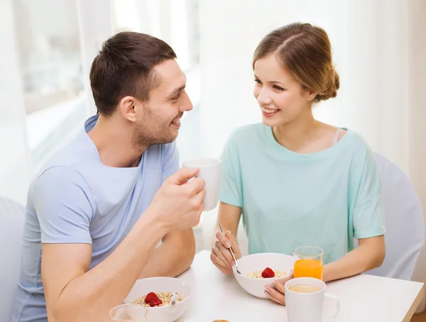 Smiling couple having breakfast at home Stock Picture