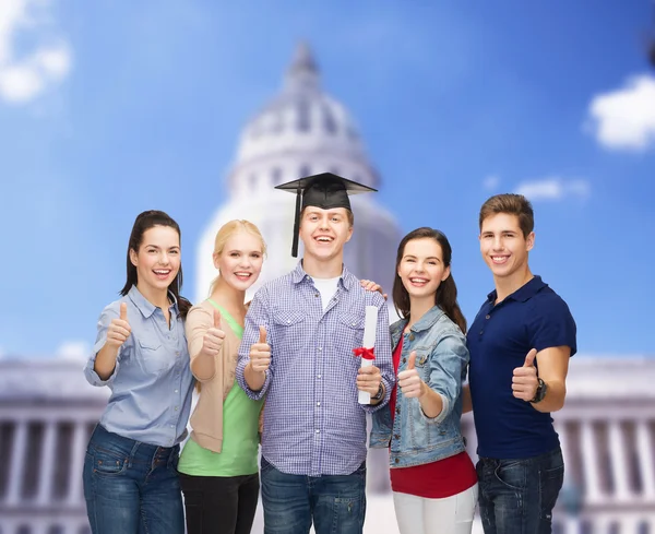 Group of students with diploma showing thumbs up — Stock Photo, Image