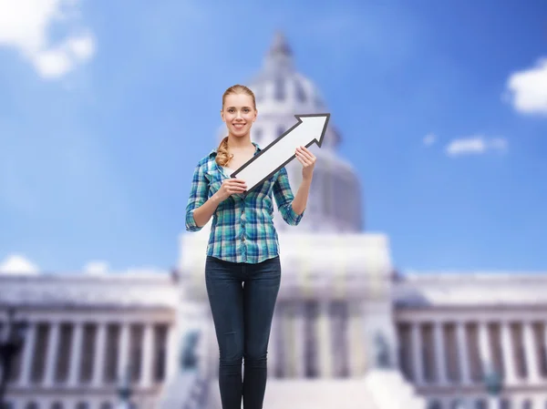 Smiling young woman with arrow poiting up — Stock Photo, Image