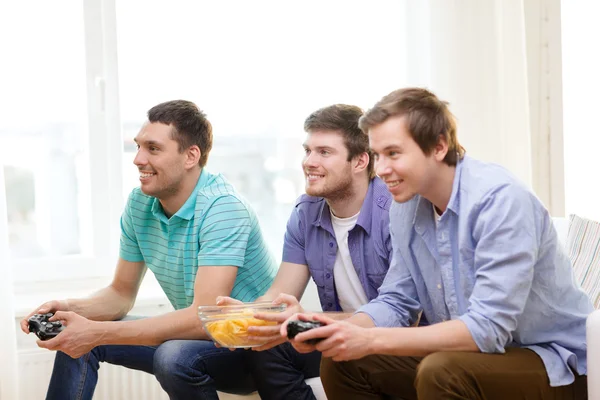 Τους φίλους χαμογελώντας παίζοντας βιντεοπαιχνίδια στο σπίτι — Φωτογραφία Αρχείου