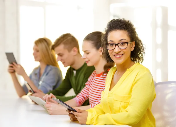 Smiling female students with tablet pc at school — Stock Photo, Image
