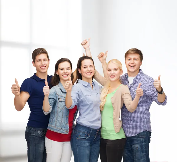 Group of smiling students showing thumbs up — Stock Photo, Image