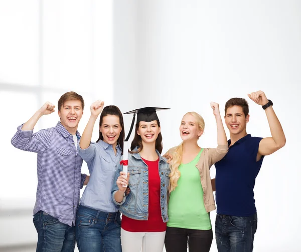 Group of standing smiling students with diploma — Stock Photo, Image