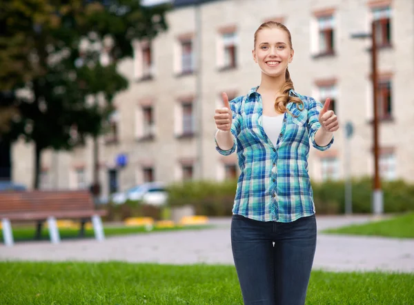 Young woman in casual clothes showing thumbs up — Stock Photo, Image
