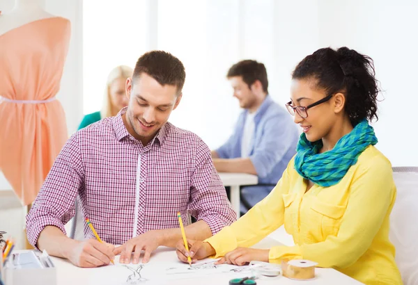 Smiling designers drawing sketches in office — Stock Photo, Image
