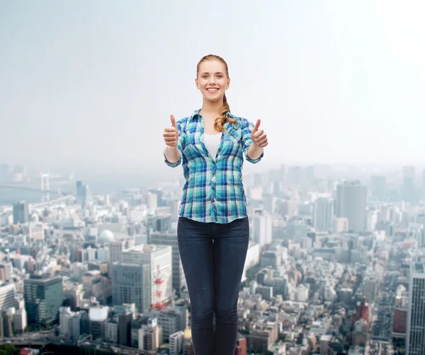 Young woman in casual clothes showing thumbs up — Stock Photo, Image