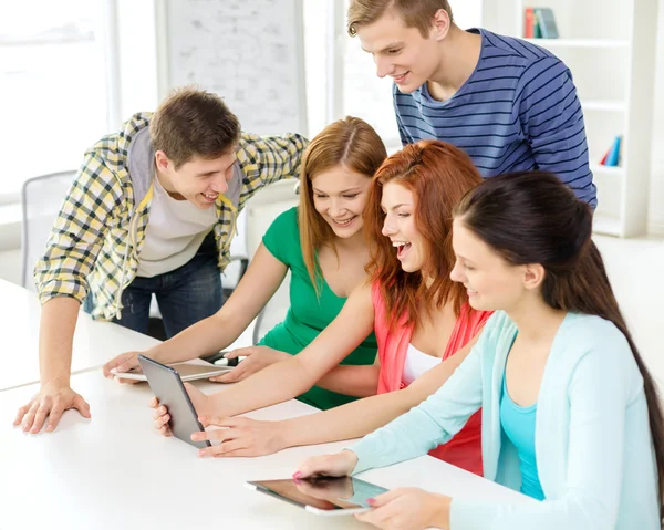 Smiling students with tablet pc at school — Stock Photo, Image