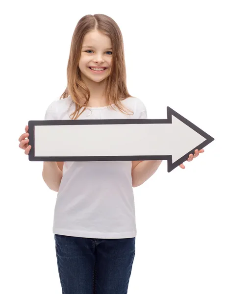 Menina sorrindo com seta em branco apontando para a direita — Fotografia de Stock
