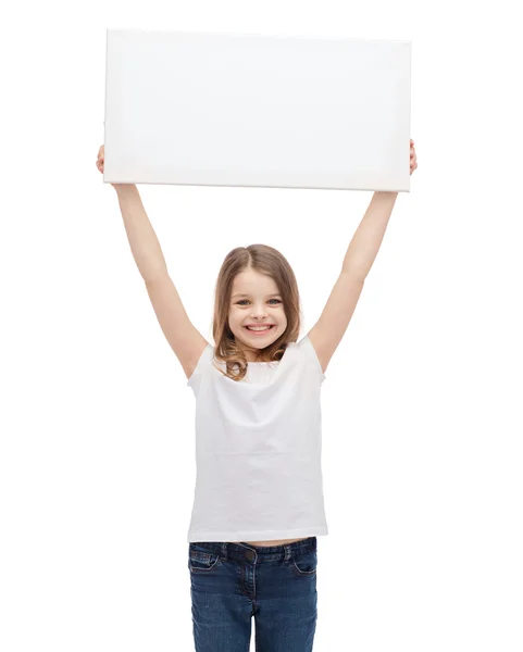 Sorrindo criança segurando placa branca em branco Imagens De Bancos De Imagens
