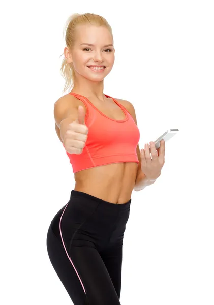 Sorrindo mulher desportiva com smartphone — Fotografia de Stock