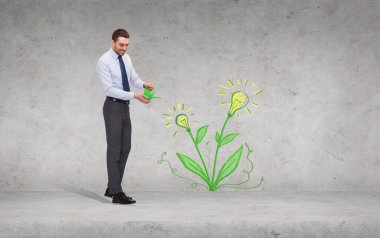 handsome businessman with green watering can clipart