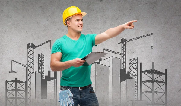 Smiling man in helmet with clipboard — Stock Photo, Image