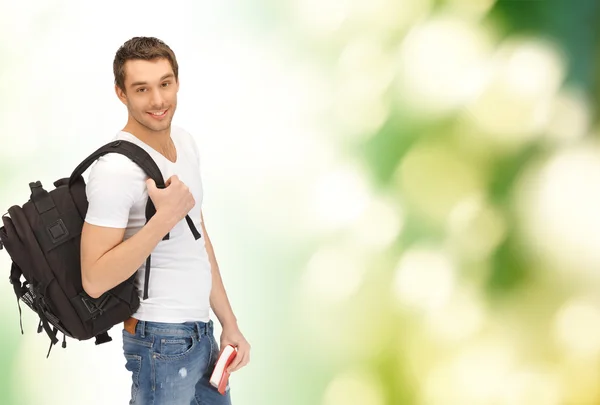 Travelling student with backpack and book — Stock Photo, Image