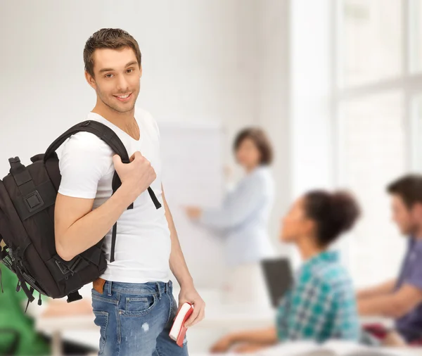 Travelling student with backpack and book — Stock Photo, Image