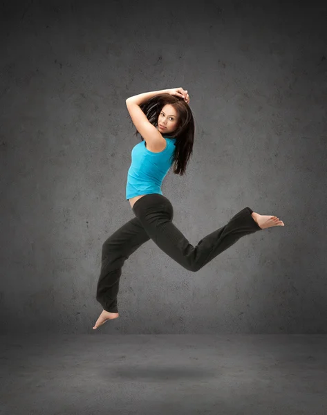 Beautiful sporty woman jumping in sportswear — Stock Photo, Image