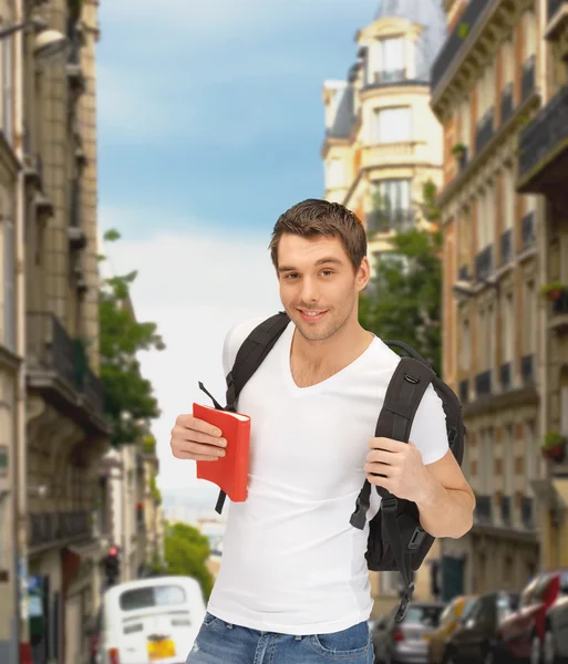 Travelling student with backpack and book — Stock Photo, Image
