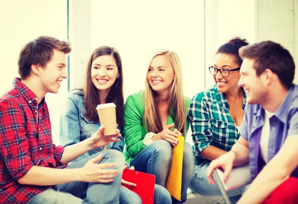 Students communicating and laughing at school — Stock Photo, Image