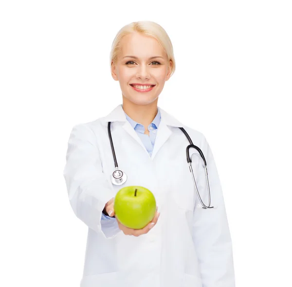 Smiling female doctor with green apple — Stock Photo, Image