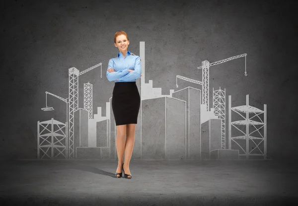 Young smiling businesswoman with crossed arms — Stock Photo, Image