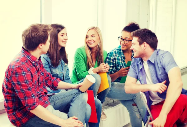 Students communicating and laughing at school — Stock Photo, Image