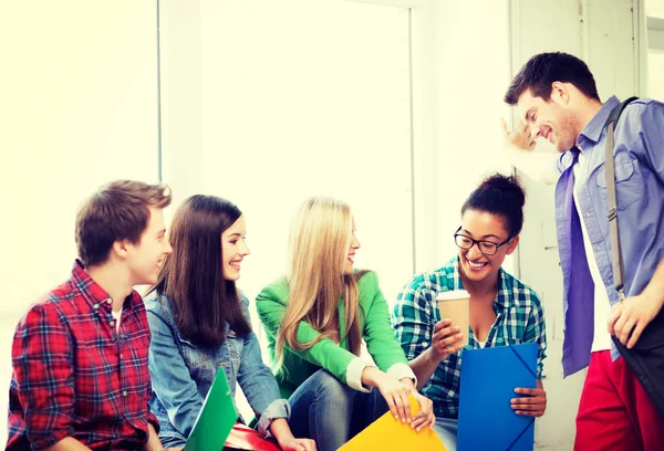 Students communicating and laughing at school — Stock Photo, Image