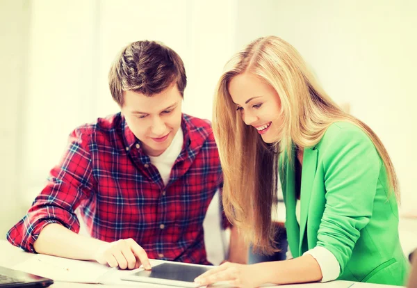Students looking at tablet pc at school — Stock Photo, Image