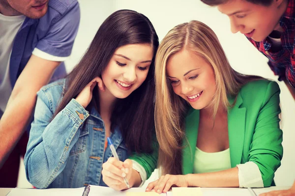 Students pointing at notebook at school — Stock Photo, Image