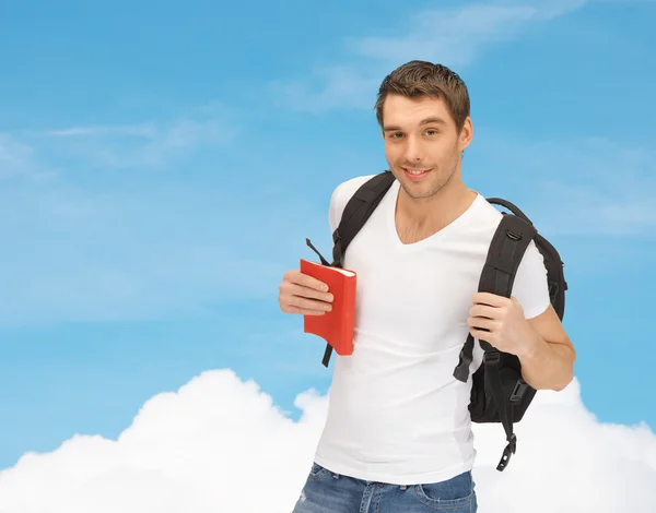 Travelling student with backpack and book — Stock Photo, Image