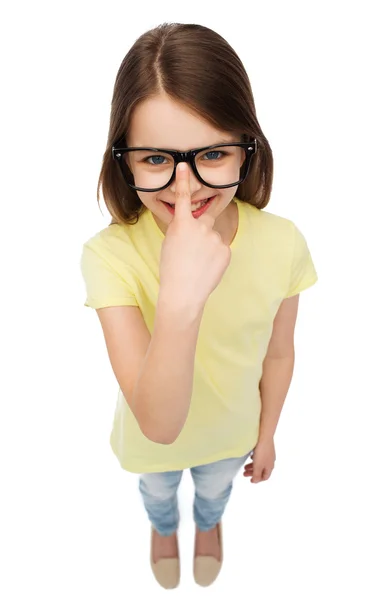 Smiling cute little girl in black eyeglasses — Stock Photo, Image