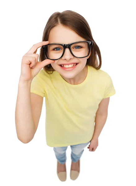 Smiling cute little girl in black eyeglasses Stock Picture