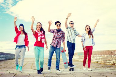 group of smiling teenagers waving hands clipart