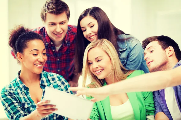 Students looking at tablet pc at school — Stock Photo, Image