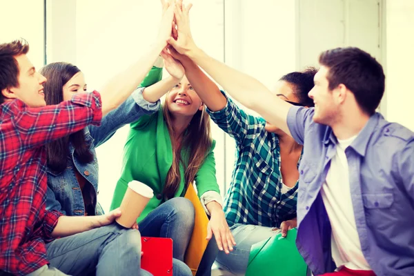 Students giving high five at school — Stock Photo, Image