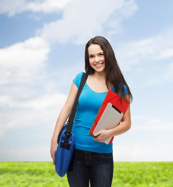 Lachende student met tas, mappen en tablet pc — Stockfoto