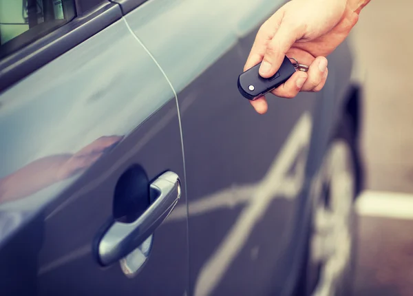 Man with car key outside Stock Picture