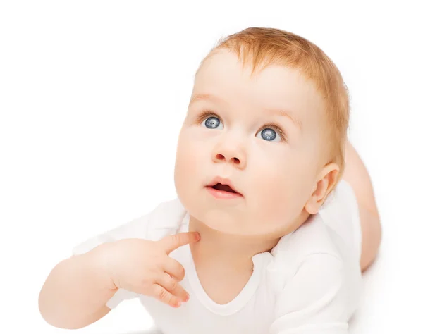 Curious baby lying on floor and looking up — Stock Photo, Image