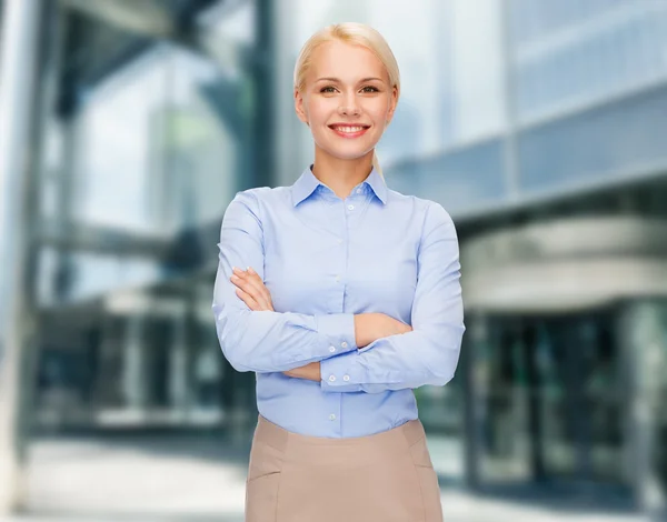 Young smiling businesswoman with crossed arms — Stock Photo, Image