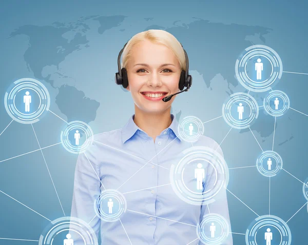 Friendly female helpline operator with headphones — Stock Photo, Image