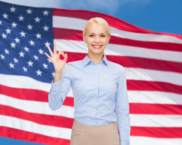 Smiling businesswoman showing ok-sign with hand — Stock Photo, Image