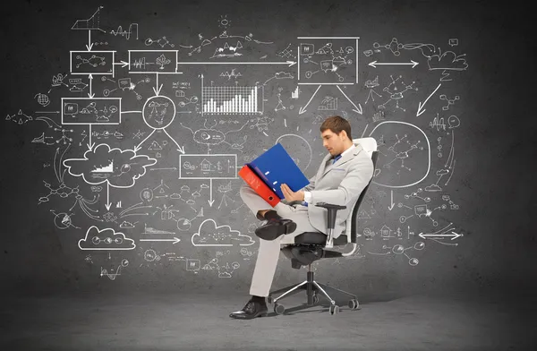 Handsome businessman with folders sitting on chair — Stock Photo, Image