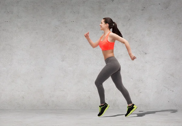 Sporty woman running or jumping — Stock Photo, Image