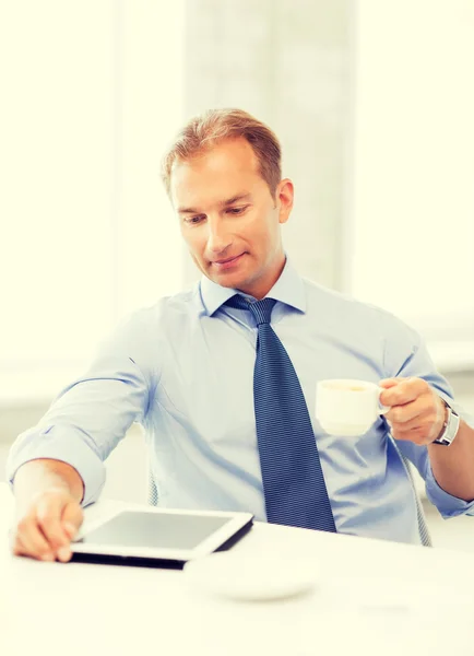 Affärsman med TabletPC och kaffe i office — Stockfoto