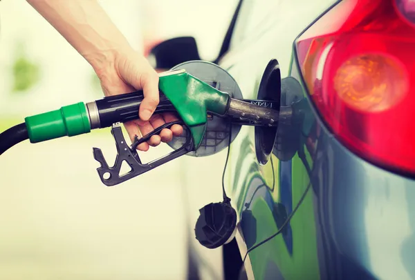 Homem bombeando gasolina combustível no carro no posto de gasolina — Fotografia de Stock