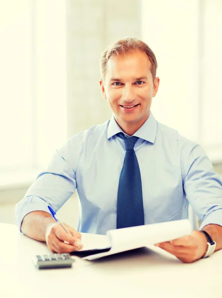 Businessman with notebook and calculator Royalty Free Stock Photos