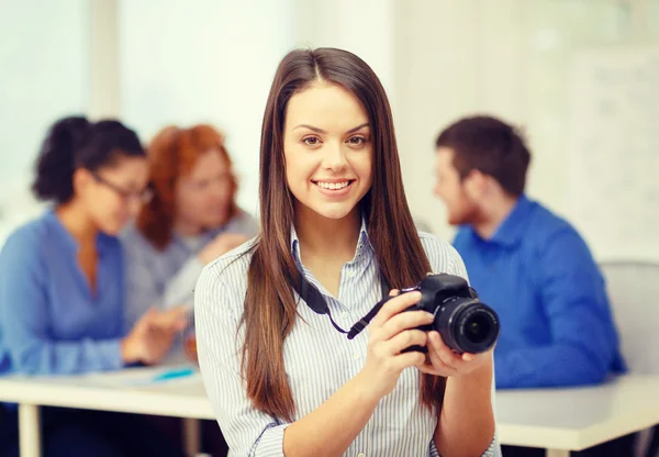 Smiling female photographer with photocamera — Stock Photo, Image